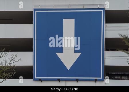 Sign huge white directional arrow on blue background Stock Photo