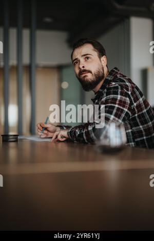 Focused man attentively listening during a business meeting discussion Stock Photo