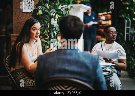 A diverse group of professionals brainstorming and strategizing over coffee in a cozy modern cafe. Stock Photo