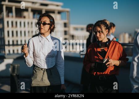 Multicultural business workers discussing a project on rooftop Stock Photo