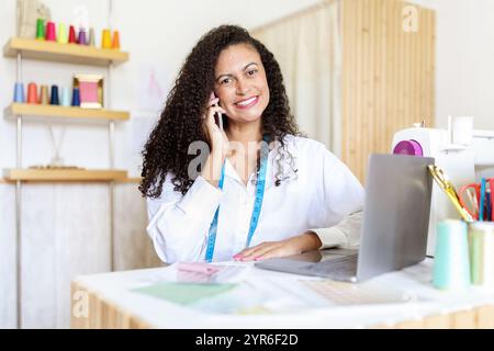 Creative designer working in an office while on a phone call Stock Photo