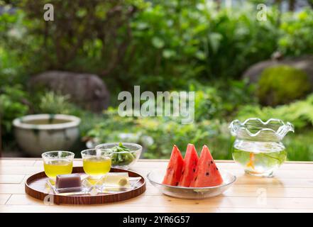 Goldfish bowl, water melon, cold tea and mizuyokan on the veranda Stock Photo