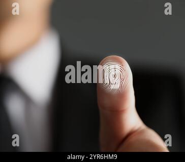Man pressing finger to surface showing friction ridges pattern, closeup. Scanning fingerprint Stock Photo