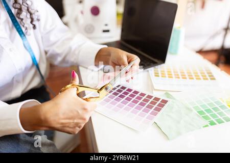 Creative designer working on fabric samples in a bright office studio Stock Photo