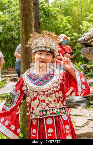 GUIZHOU, GUIYANG, CHINA, 16 AUGUST, 2022: A girl wearing traditional Miao clothes in Yelang Valley, a magical place filled with stone castles, towerin Stock Photo