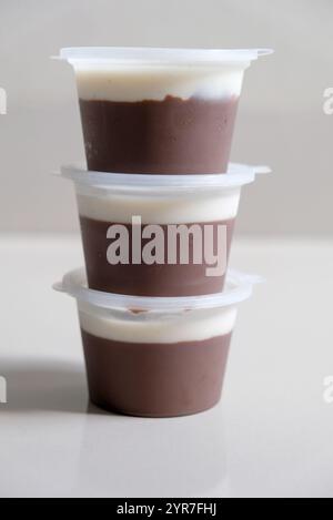 Chocolate pudding dessert with vanilla fla in a plastic cup. Stock Photo