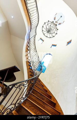 Winding spiral staircase with ornate wooden railings Stock Photo - Alamy
