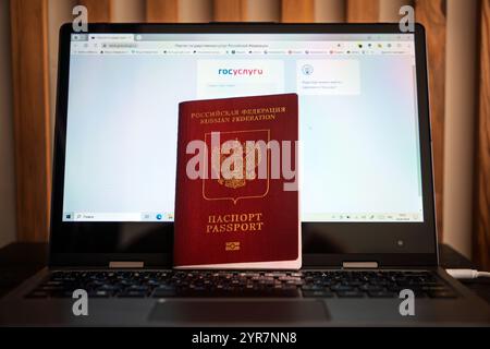 Passport of the Russian Federation on a black laptop keyboard. Identification of the user on the Internet. the website of public services on the scree Stock Photo