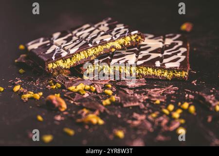 Dubai Chocolate bar with green kadayif and pistachio spread on brown background Stock Photo