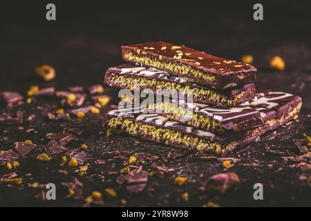 Dubai Chocolate bar with green kadayif and pistachio spread on brown background Stock Photo