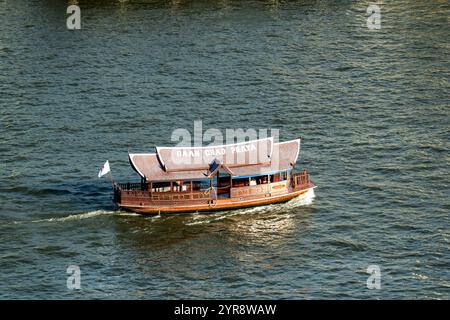 Experience a traditional boat ride on the Chao Phraya River in Bangkok Stock Photo