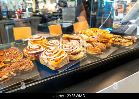 Freshly baked pastries displayed with enticing cinnamon rolls and croissants Stock Photo