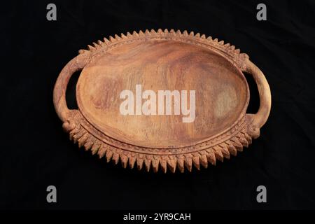 handmade wooden decorative empty dish plate on black background Stock Photo