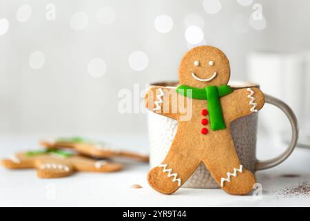 Gingerbread man in front of mug of hot chocolate Stock Photo