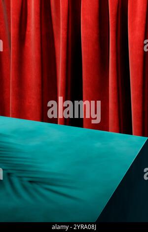 Modern color background with palm shadow on blue table with red backdrop. Trendy colorful interior studio scene for luxury product showcase. Stock Photo