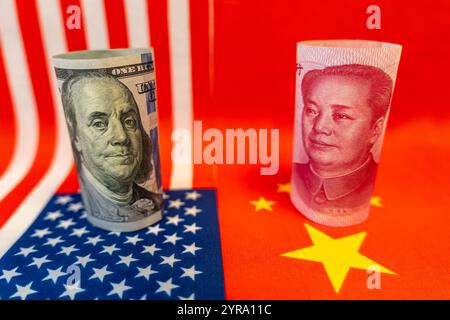 Close up of 100 Yuan banknote and one hundred Dollar banknotes with focus on portraits of Benjamin Franklin and Mao Tse-tung against the background of Stock Photo