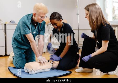 A man and a woman in scrubs are working together, possibly performing a medical procedure or assisting a patient in a healthcare setting. Stock Photo