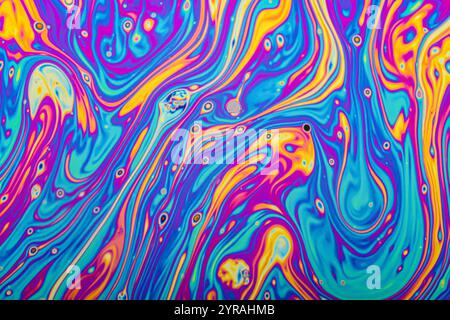 Real closeup photograph of a soap bubble surface movements as a scientific experiment showing light refraction with colorful shapes and forms Stock Photo