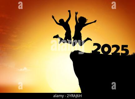 Silhouette of a person jumping joyfully at sunset while celebrating the arrival of 2025 Stock Photo