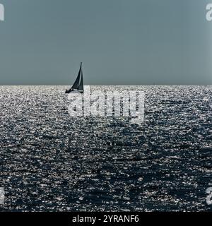 Small sailing boat on the glinting waves of the Baltic Sea Stock Photo