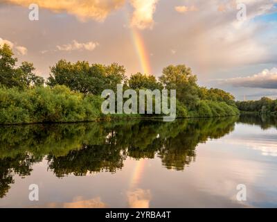 Rainbow and dark clouds over the Gieselau Canal at sunset, Schleswig-Holstein, Germany Stock Photo