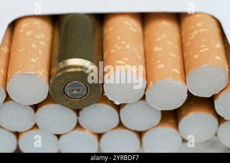 Bullet in cigarette box Stock Photo