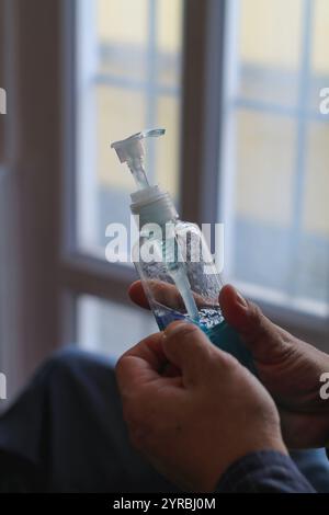 A young businessman uses alcohol gel prepared in the office to wash his hands after attending a meeting to clean his hands and disinfect the virus dur Stock Photo