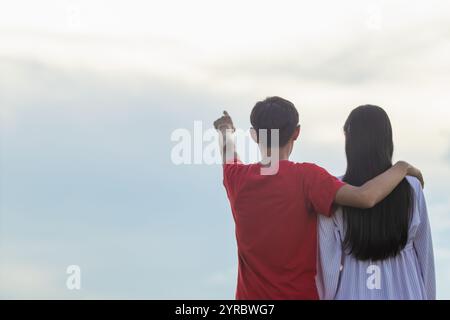 Smooth Focus, young man embraces woman's shoulder to show love and care and promises to care for each other with love and compassion. concept of lovin Stock Photo