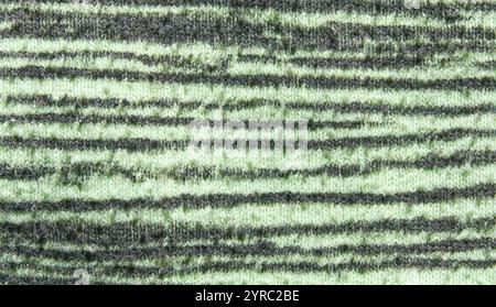 Close up of textured green and black striped fabric surface pattern. Stock Photo