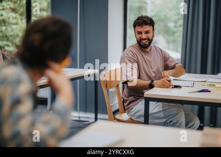 Students in classroom engaged and discussing during classes, collaborating and smiling in a positive atmosphere. Stock Photo