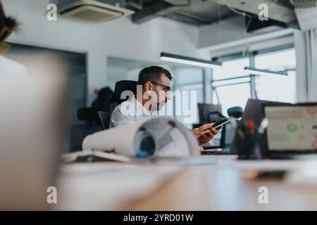 Focused business professional working at modern office desk Stock Photo