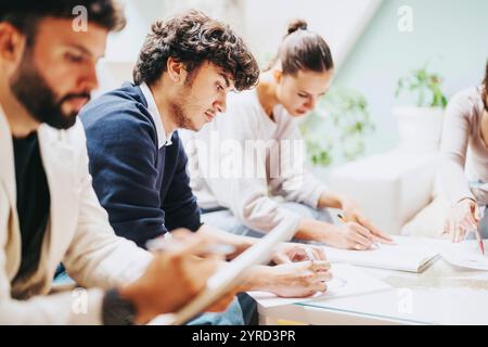 High school students collaborate on a school project with their professor in a comfortable home environment, engaging in learning and study. Stock Photo
