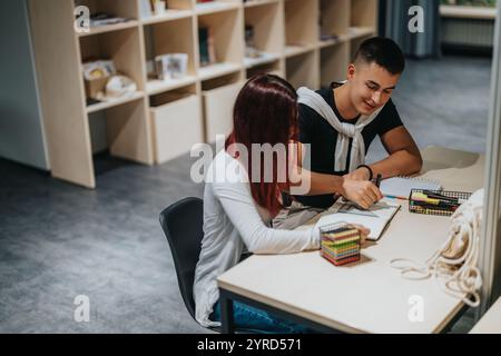 Students collaborating on a study project in a school library Stock Photo
