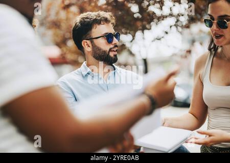 Business people engaging in a collaborative outdoor discussion Stock Photo