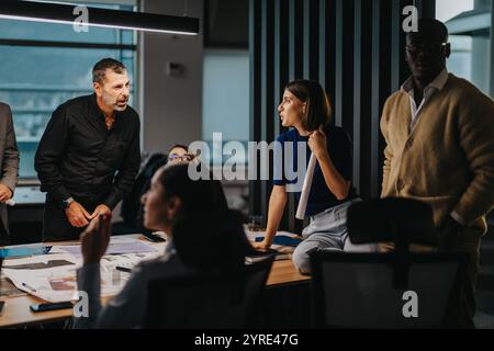 Diverse team engaging in a collaborative office meeting discussion Stock Photo