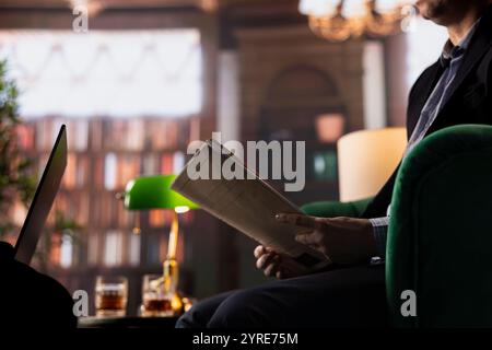 Diverse agents in a CIA headquarters library analyzing confidential data and reflecting on strategy for an intelligence service mission. Gathering important information for the government. Stock Photo