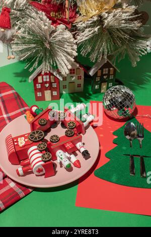 Christmas decorations on a plate on the table. Minimal surrealism Stock Photo