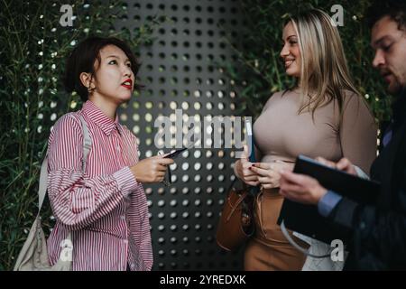 Business professionals having a lively outdoor team discussion Stock Photo