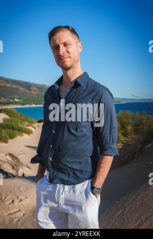 Man on Sandy Dune Overlooking Atlantic Ocean Near Tarifa, Spain Stock Photo