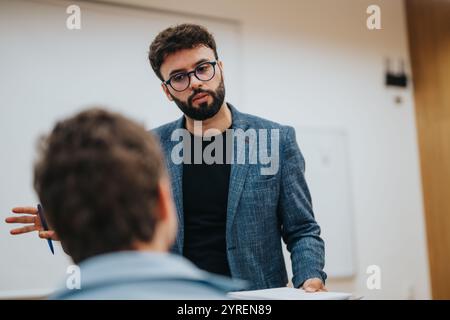 Professor engaging in thoughtful discussion with attentive students Stock Photo