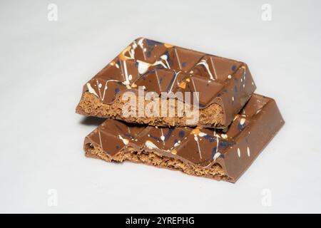 Trend Dubai chocolate bar with nutella and kataifi dough filling on white background. Confectionery and sweets. Stock Photo