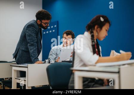 College students collaborating on assignments with professor assistance Stock Photo