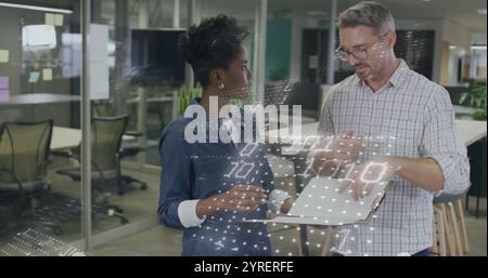 Image of binary coding over diverse colleagues discussing work Stock Photo