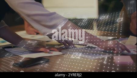 Image of binary coding over diverse colleagues discussing project Stock Photo
