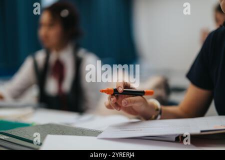 Students engaging in class tasks with supportive professor assistance Stock Photo