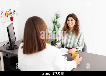 Businesswomen engaged in a productive meeting in a modern office setting Stock Photo