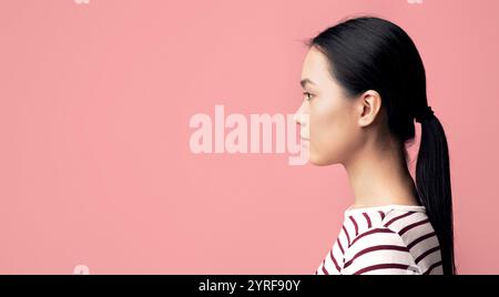 Profile Portrait Of Young Beautiful Asian Woman Looking At Copy Space Stock Photo
