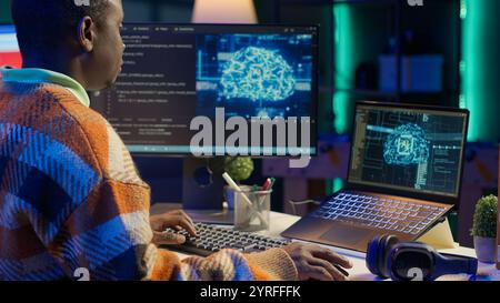 Black man programmer manages code and scripts in artificial ...