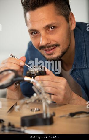 watchmaker is repairing the mechanical watches in his workshop Stock Photo