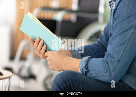 cropped image of man reading a book Stock Photo